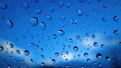 Blue sky with rain drops on glass water drops