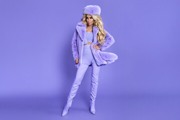 Elegant Fashion Woman in Pastel Lilac Faux Fur Coat and Hat on Matching Purple Background, Trendy Winter Monochrome Style Portrait