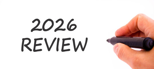 2026 Review symbol. Concept words 2026 Review on beautiful white paper. Beautiful white paper background. Businessman's hand with pen. Business and 2026 review concept. Copy space.