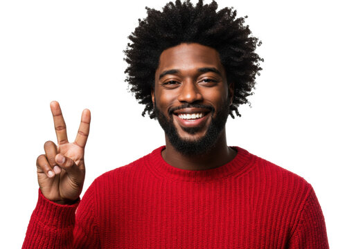 young african american man in a chunky red knit sweater, full afro and beard, wide smile showing teeth, making a v-sign hand gesture near face. studio portrait, white backdrop, sharp focus, high-key