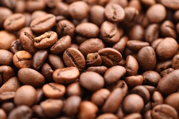 Textured background of freshly roasted coffee beans close up