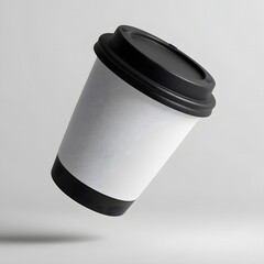 Floating disposable coffee cup with black lid isolated on clean grey background