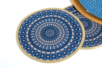 Obraz premium Blue circular placemats with geometric pattern on a white background.