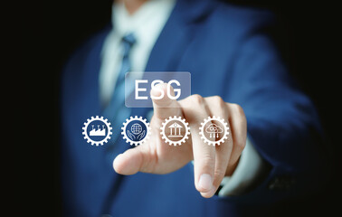 Man using laptop with ESG, ESG environmental, social and governance. icons on virtual screen for world sustainable environment concept.
