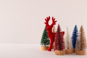 Red Christmas reindeer on white background. Happy Christmas idea and holiday concept. Copy space