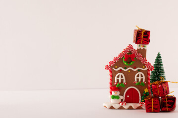 Gingerbread house with gifts isolated on a white background. Christmas holiday concept.