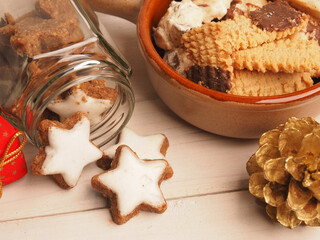 Tasty organic cinnamon stars on a wooden table with Christmas decoration