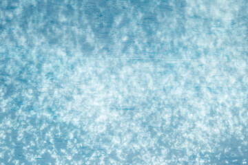 Obraz premium Abstract light pattern on blue background, light on wood background