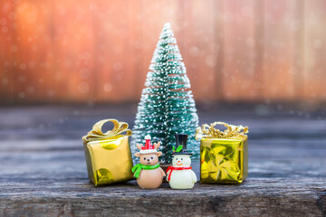Reindeer and snowman with gift box and Christmas tree over blurred background, Christmas card background idea