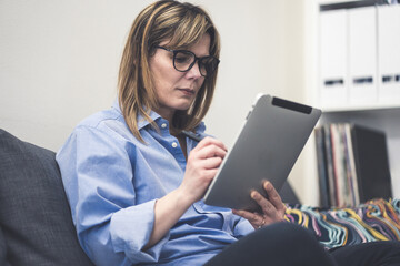 Woman uses stylus on tablet. Girl write with digital pen on device. Modern and efficient workflow