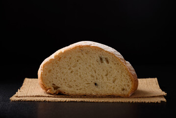Freshly baked sourdough bread   on a black background