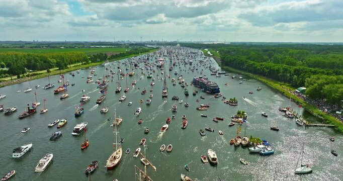 Aerial view of Sail Amsterdam 2025, Sailing Parade in Amsterdam in August 2025. Many ships and boats of different sizes participate in the festival, sailing along the main canal leading to Amsterdam