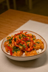 Delicious Asian Style Chicken with Rice and Vegetables in Ceramic Bowl