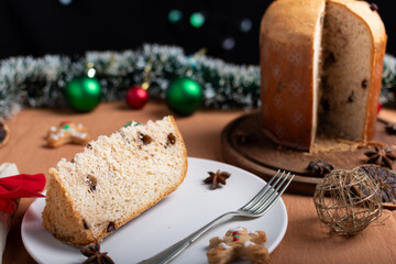 Slice of panettone on a Christmas table.