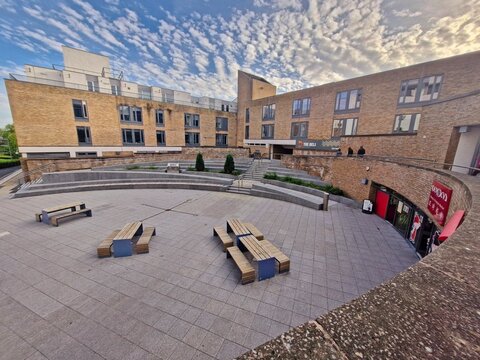 LANCASTER UNIVERSITY, UK - JULY 16, 2025 : Students and visitors walk through the student facilities area at Lancaster University, featuring campus shops, cafes and restaurants within the uni grounds.