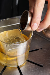 A delicious alcoholic cocktail at the bar. The bartender prepares cocktails