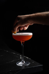 A delicious alcoholic cocktail at the bar. The bartender prepares cocktails