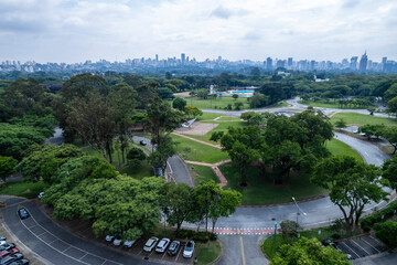 Aerial view of USP campus in Sao Paulo showing buildings, green spaces, and city skyline