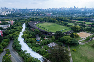 Aerial view of USP campus in Sao Paulo showing buildings, green spaces, and city skyline