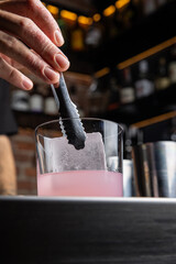 A delicious alcoholic cocktail at the bar. The bartender prepares cocktails
