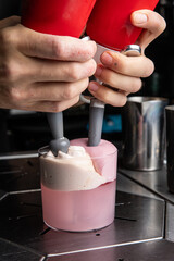 A delicious alcoholic cocktail at the bar. The bartender prepares cocktails