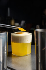 A delicious alcoholic cocktail at the bar. The bartender prepares cocktails