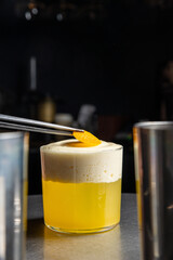 A delicious alcoholic cocktail at the bar. The bartender prepares cocktails