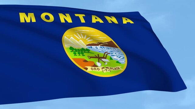 Montana flag is waving against a clear blue sky.