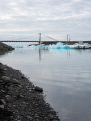 Bridge over Glacier Lagoon in Iceland with icebergs floating