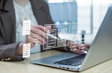 Businesswoman reviewing digital policy documents on a laptop, illustrating data governance, corporate compliance, secure document management, and cybersecurity oversight.