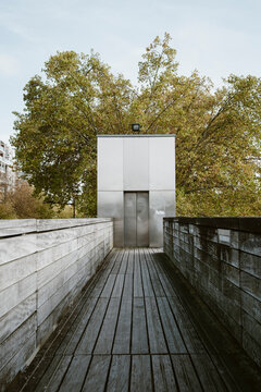 A wide Paris road showcases urban architecture and city mobility through modern exterior light, empty street depth and pavement geometry shaping the quiet atmosphere