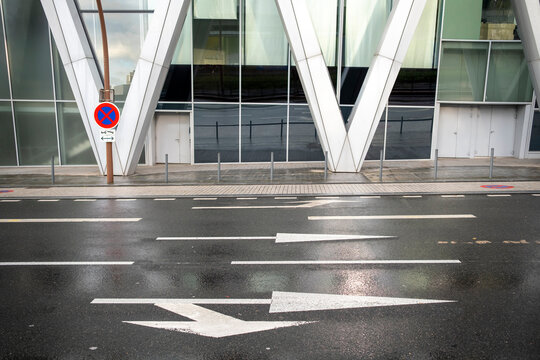 Modern urban mobility defines the empty Paris road as city architecture frames a clean street marked by pavement textures and soft exterior light across the scene