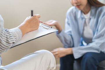 Psychology, depression. Suffer asian young woman consultation with psychologist while patient...