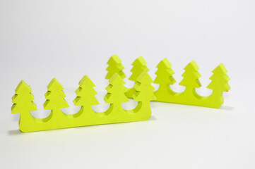 Unique neon yellow foam toe separator shaped like five pine trees, isolated on a clean white background. Essential tool for pedicure, manicure, spa treatment, and nail care accessory.