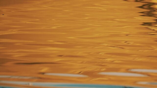Abstract close up of a yellow boat reflection on the water