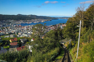View down the train track of the Floibanen funicular from the top of Mount Fl&oslash;yen. Spectacular panoramic view over the city, fjord and mountains, Bergen, Norway.