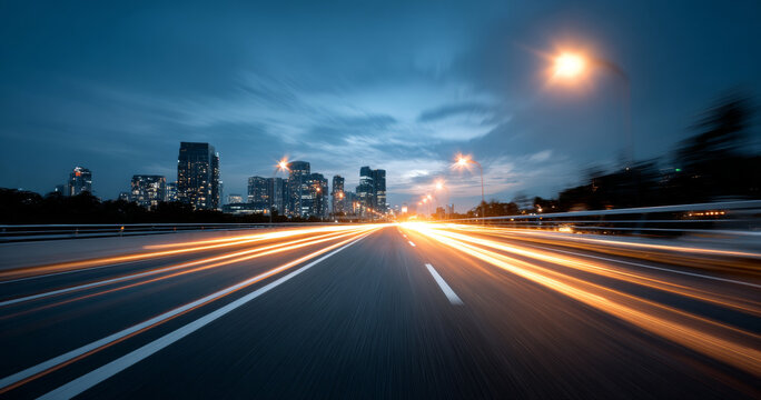 Long exposure cityscape at dusk with light trails on highway leading towards illuminated urban skyline and streetlights under cloudy sky - Powered by Adobe