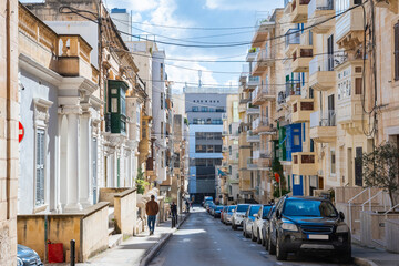 Fototapeta premium Cozy street and traditional colorful wooden balconies in Sliema, Malta