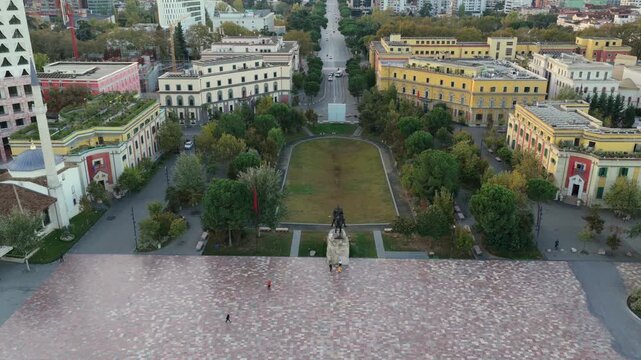 Aerial video of Skanderbeg Square at Dawn surrounded by modern towers and city landmarks.