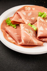 Mortadella sausage slices meat food tasty snack fresh delicious gourmet food background on the table rustic food top view copy space