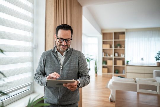 Man using digital tablet for smart home management