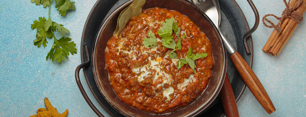 Dal makhani with cream and coriander in bowl is served with spices, traditional dish of India