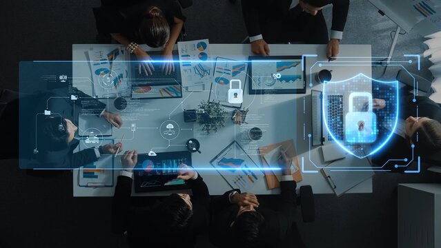 A dynamic office scene featuring a business meeting focused on cybersecurity strategies, showcasing teamwork and digital interface with data protection concepts. Raster - Powered by Adobe