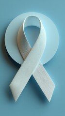Light blue awareness ribbon on circular disk, symbolizing support for various causes and health initiatives