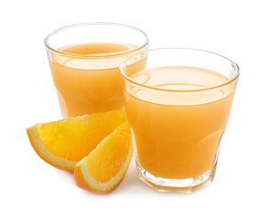 Glasses of fresh orange juice and fruit slices isolated on white
