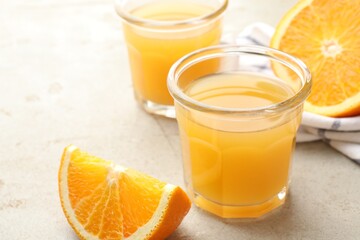 Fresh orange juice and fruits on light table, closeup. Space for text