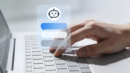 Hand typing on laptop with chatbot icon