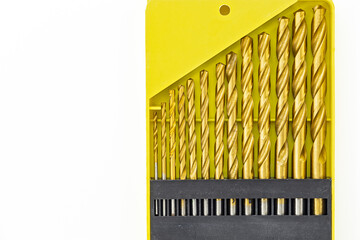 Set of gold drill bits in a bright yellow case for tool enthusiasts