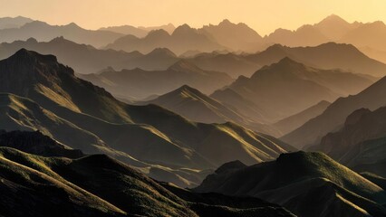 Fototapeta premium A sweeping panorama of layered mountains glowing in warm sunrise light. Concept Sunrise landscape panorama, Layered mountains at dawn, Golden hour mountain glow, Wide-angle nature photography
