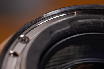 Macro image of a damaged rubber weather seal on a pro lens in need of repair.